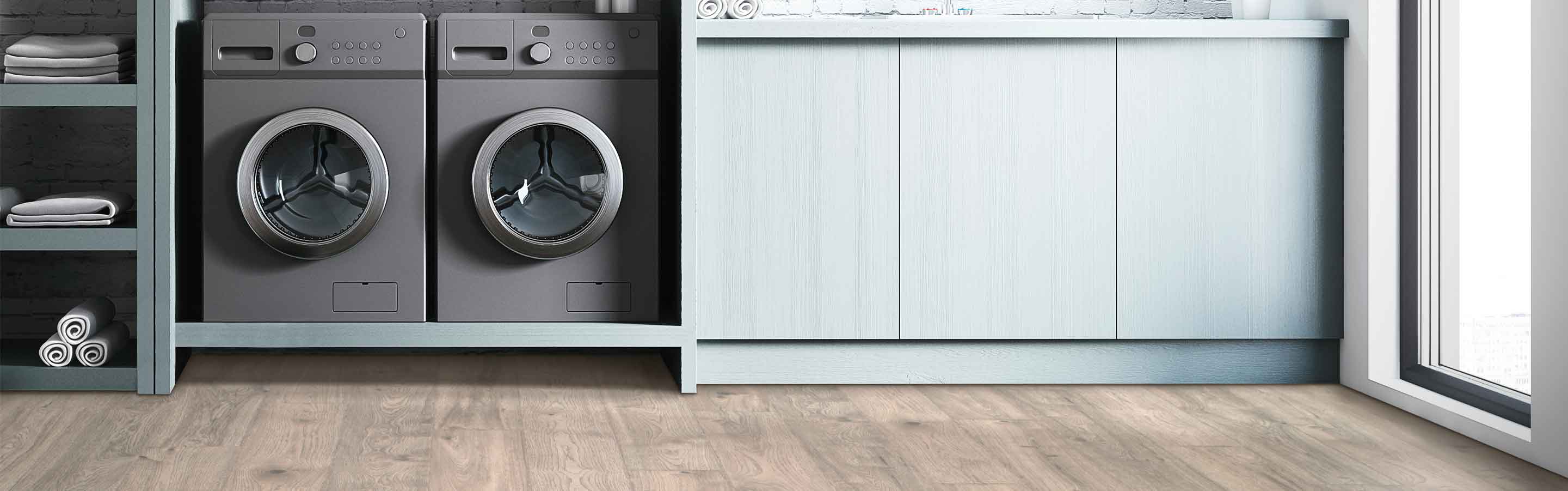 natural wood-look laminate flooring in laundry room with gray washer and dryer